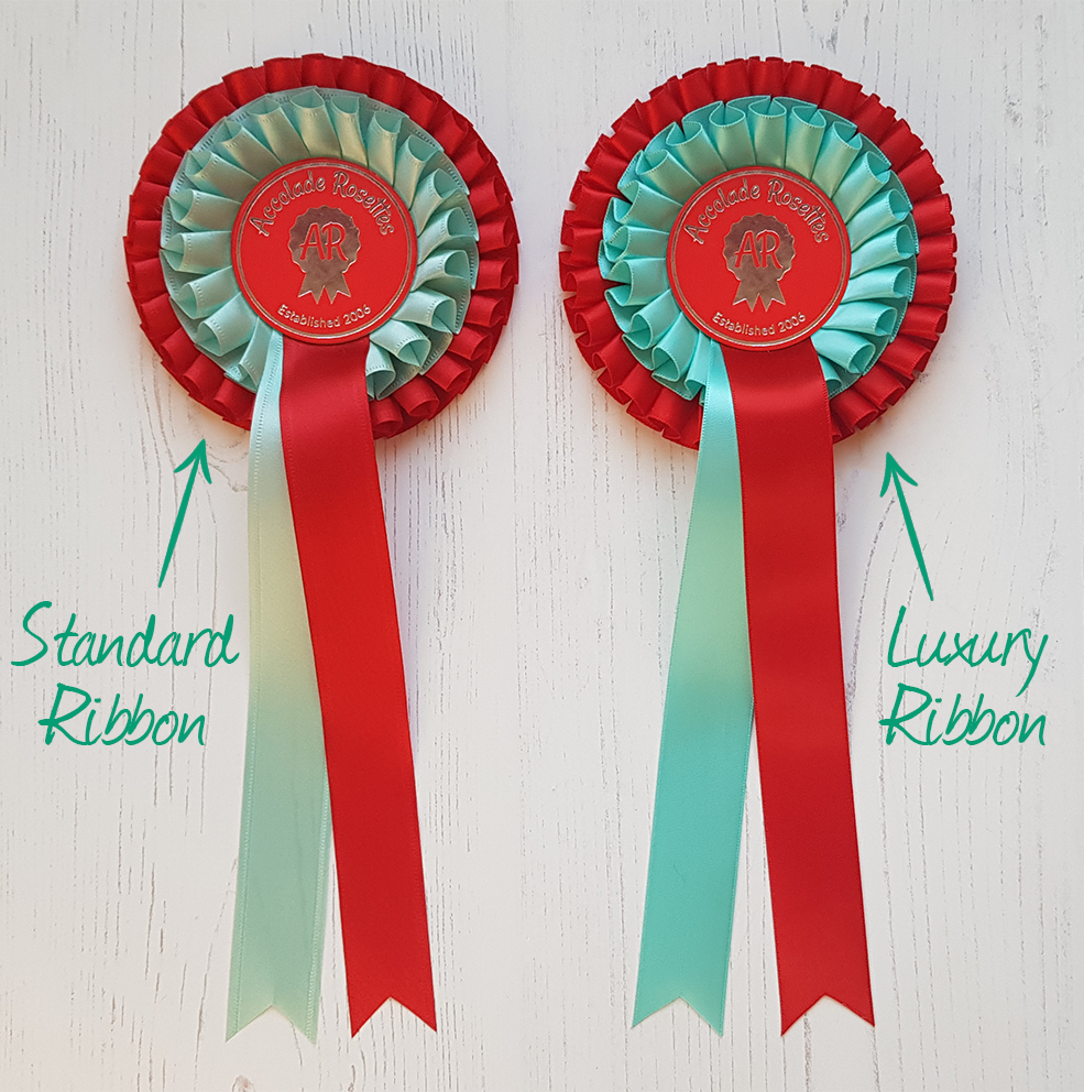 Spot the difference: two F502 rosettes; one made using our Standard Ribbon and the other made using our Luxury Ribbon